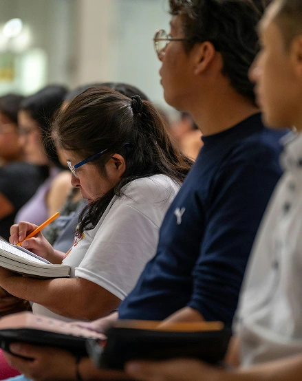 People attending a workshop and taking notes