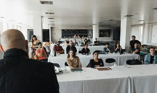 A man conducting a workshop that is being attended by several people